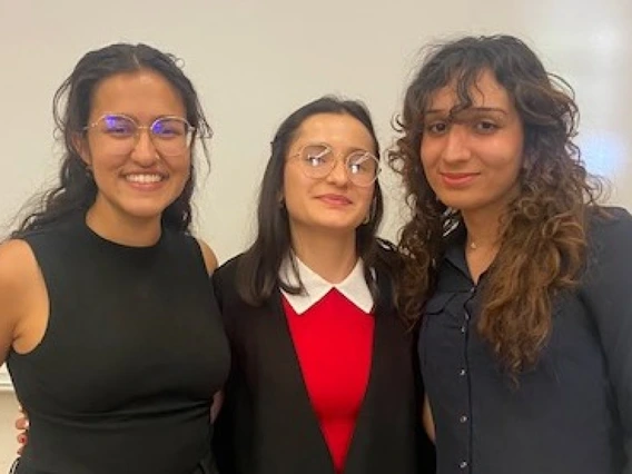 Picture of three women in front of whiteboard