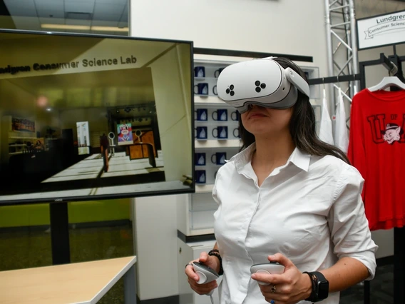 Retailing and consumer science student Nicole Gil-Lopez uses a Meta Quest 3 headset to explore the student‐created virtual reality “digital twin” of the Lundgren Consumer Science Lab. She and her classmates in a merchandising systems course are using extended reality technology to discover new ways of learning.