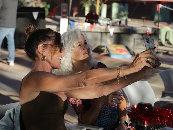 Two women pose for a selfie during the Norton School Homecoming Celebration