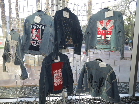 Six denim jackets designed by students in the Fashion Industry's Science and Technology program