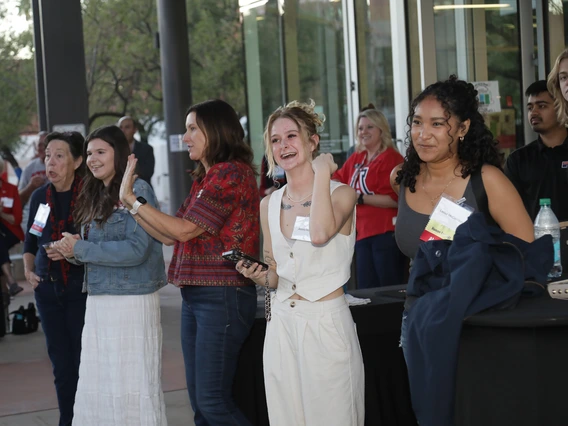 A line of Wildcat women looks on at the alumni fashion show