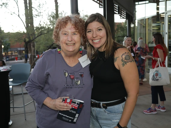 Two women pose at the Norton School Homecoming Celebration