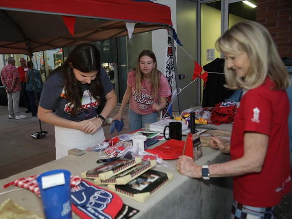 Norton alumni peruse auction items at the Homecoming Celebration