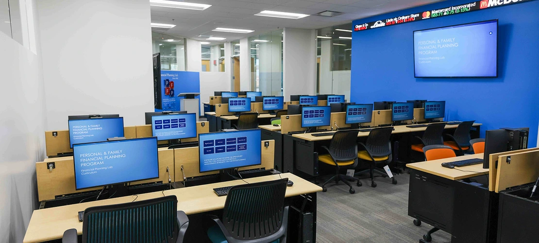A room with computer desks and monitors.