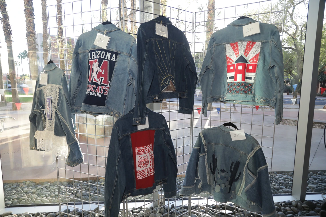Six denim jackets designed by students in the Fashion Industry's Science and Technology program