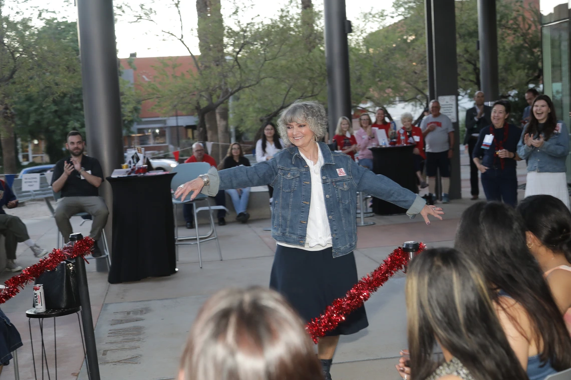 A Norton alumna twirls on the catwalk at the Norton Alumni Fashion show