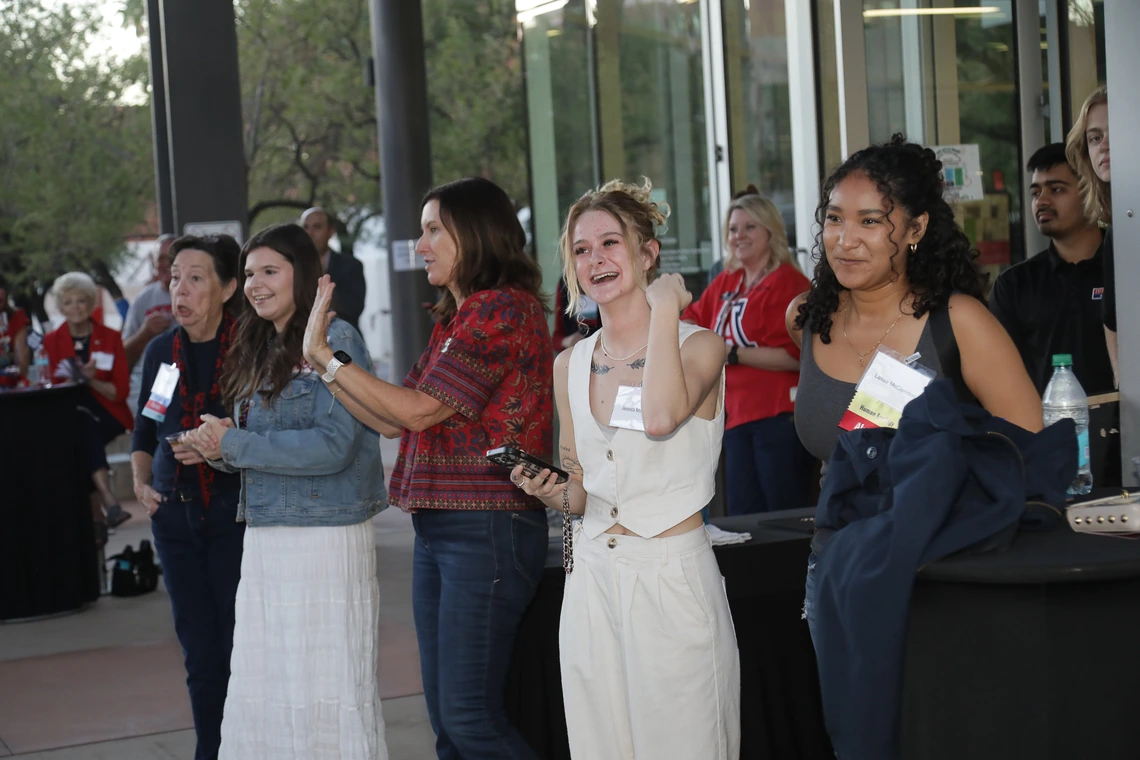 A line of Wildcat women looks on at the alumni fashion show
