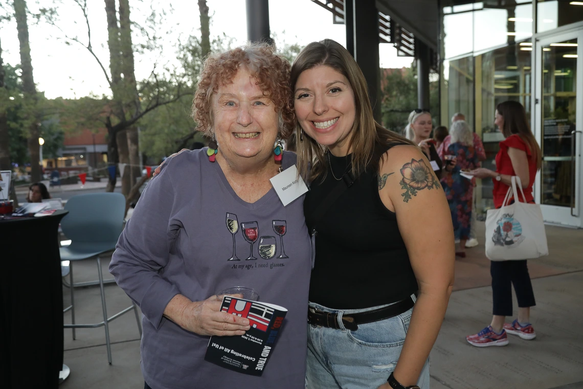 Two women pose at the Norton School Homecoming Celebration