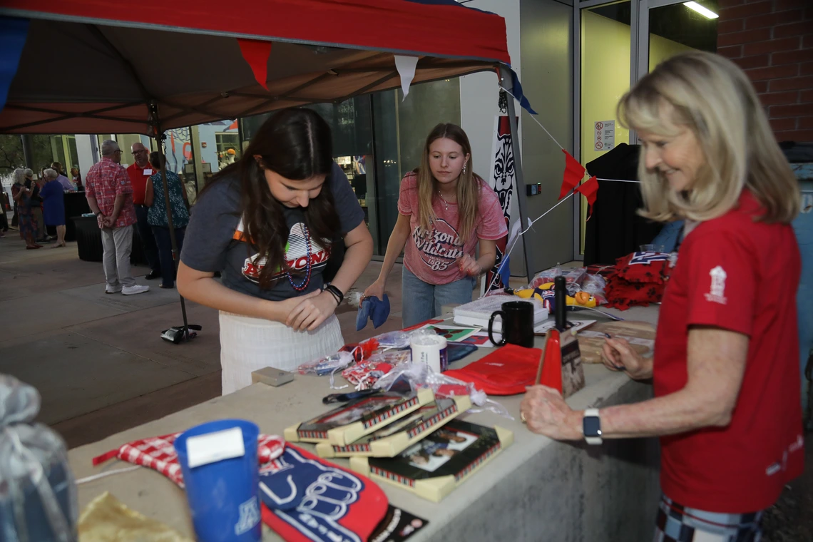 Norton alumni peruse auction items at the Homecoming Celebration