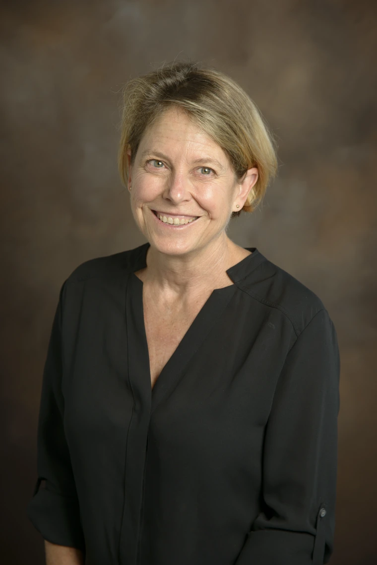 Image of short-haired middle-aged woman in black blouse