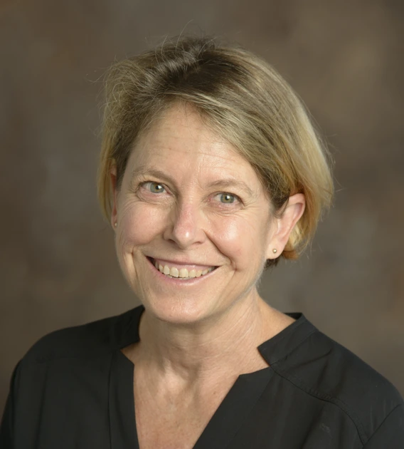 Image of short-haired middle-aged woman in black blouse