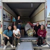 Tenley Higgins loading truck with Christmas gifts