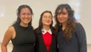 Picture of three women in front of whiteboard