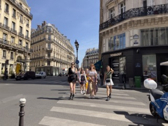 Fashion students from the university of arizona walking across the street in europe on their study abroad trip