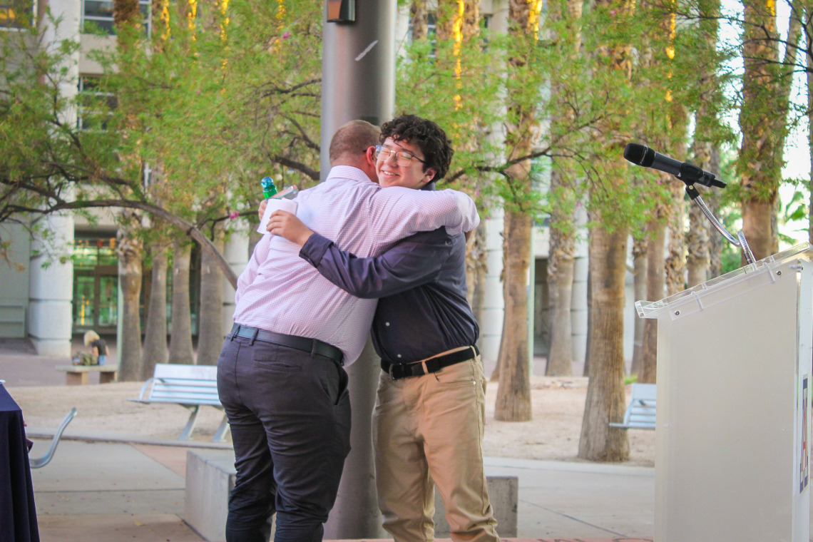 Frances McClelland Youth Vision Awardee, Daniel Trujillo, and longtime mentor and FSHD faculty, Russ Toomey, share a hug as Daniel accepts his award.