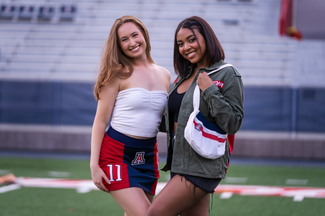 University of Arizona undergraduate students Erika Gay (right) and Jade Butcher model clothing and accessories from the Arizona Replay clothing line, which incorporates retired UArizona football jerseys and thrifted clothing.Drew Bourland/University of Arizona Marketing and Brand Management